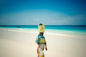 A woman on the beach near the turquoise sea